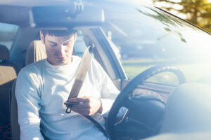 driver holding seat belt