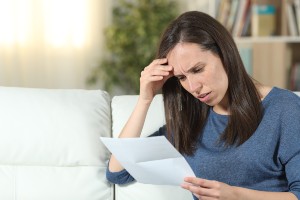 worried woman reading letter
