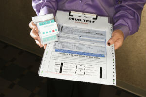 handing drug test kit to someone