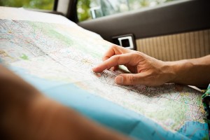 hands looking at a road mpa