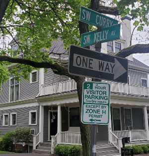 corner near a house with street signs