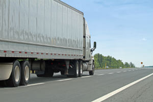 truck driving down road during day