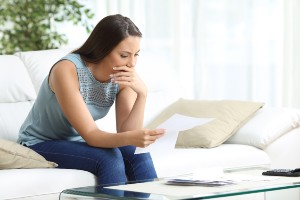 young female upset while reading document
